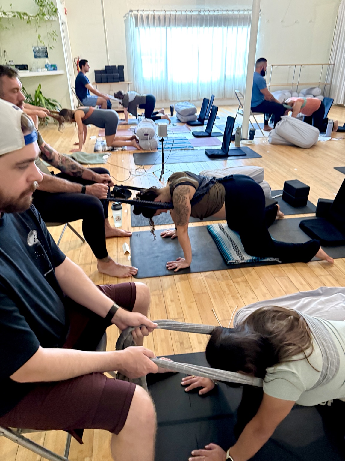 Birth partners practicing hands-on comfort measures together during a labor-support workshop